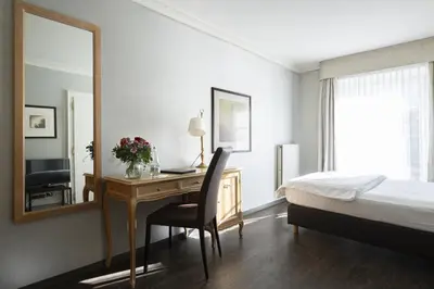 Ein Bett oder Betten in einem Zimmer der Unterkunft Grand Hotel Beau Rivage Interlaken