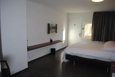 Ein Bett oder Betten in einem Zimmer der Unterkunft Hotel Du Soleil