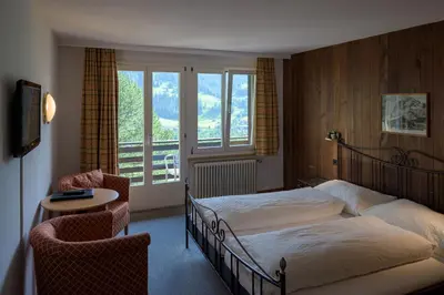 Ein Bett oder Betten in einem Zimmer der Unterkunft Hotel Tschuggen