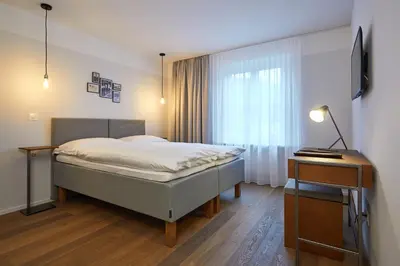 Ein Bett oder Betten in einem Zimmer der Unterkunft Italian Lifestyle Hotel & Osteria Chartreuse