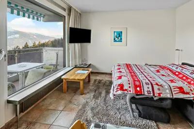 Ein Bett oder Betten in einem Zimmer der Unterkunft Appartement à Crans-Montana - avec magnifique vue sur la vallée