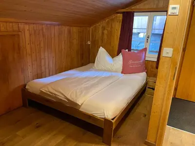 Ein Bett oder Betten in einem Zimmer der Unterkunft Hotel Jägerstübli Grindelwald