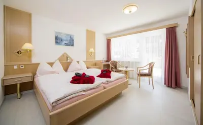 Ein Bett oder Betten in einem Zimmer der Unterkunft Wellness- und Schneesporthotel Christiania