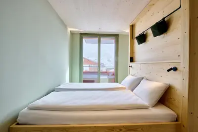 Ein Bett oder Betten in einem Zimmer der Unterkunft Apart Hotel Adelboden am Dorfplatz