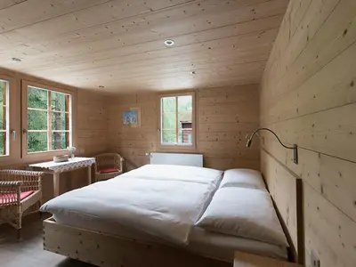 Ein Bett oder Betten in einem Zimmer der Unterkunft Hotel Fafleralp