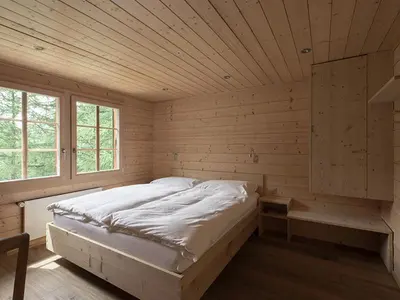 Ein Bett oder Betten in einem Zimmer der Unterkunft Hotel Fafleralp