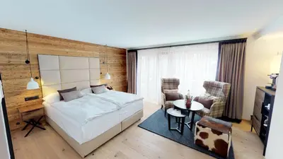 Ein Bett oder Betten in einem Zimmer der Unterkunft Walliserhof Grand-Hotel & Spa Relais & Châteaux