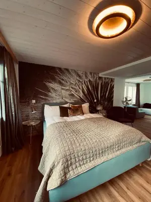Ein Bett oder Betten in einem Zimmer der Unterkunft Boutique Hotel Bellevue B&B am Brienzersee Iseltwald Interlaken
