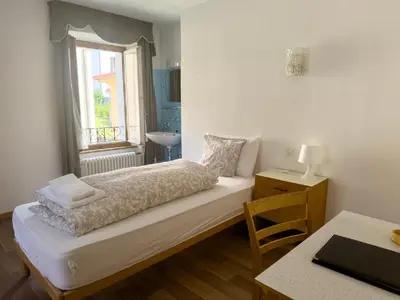 Ein Bett oder Betten in einem Zimmer der Unterkunft Hotel Des Alpes - Restaurant & Pizzeria