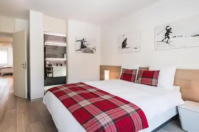 Ein Bett oder Betten in einem Zimmer der Unterkunft Ascot-Zermatt