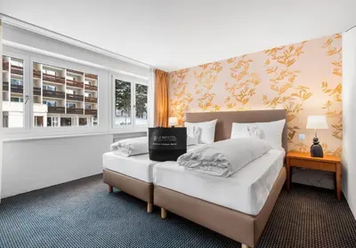Ein Bett oder Betten in einem Zimmer der Unterkunft Le Bristol Leukerbad