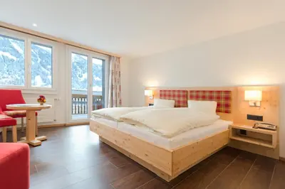 Ein Bett oder Betten in einem Zimmer der Unterkunft Hotel Caprice - Grindelwald