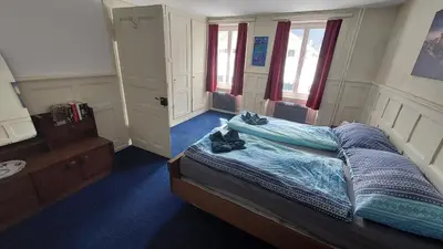 Ein Bett oder Betten in einem Zimmer der Unterkunft Ferienwohnung Rothorn Meiringen