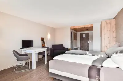Ein Bett oder Betten in einem Zimmer der Unterkunft Rhodania 56