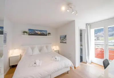 Ein Bett oder Betten in einem Zimmer der Unterkunft Eiger Residence