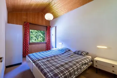 Ein Bett oder Betten in einem Zimmer der Unterkunft Superbe appartement, en 2 parties, au centre d'Anzère