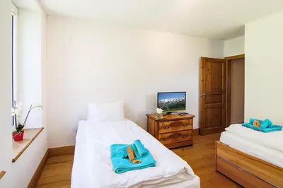 Ein Bett oder Betten in einem Zimmer der Unterkunft Le Manoir 5