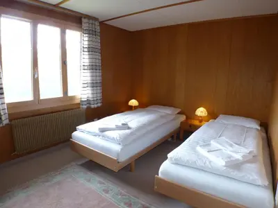 Ein Bett oder Betten in einem Zimmer der Unterkunft Chalet Eigersunne 2