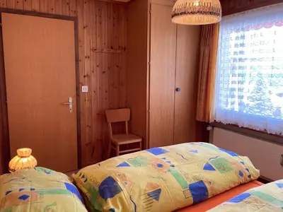 Ein Bett oder Betten in einem Zimmer der Unterkunft Chalet Sunnuterrasse