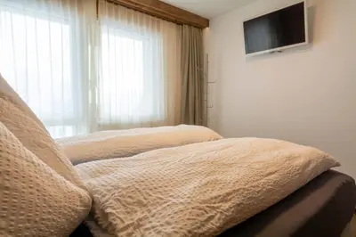 Ein Bett oder Betten in einem Zimmer der Unterkunft Chalet Weisshorn 1