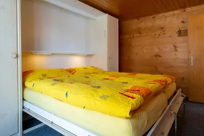 Ein Bett oder Betten in einem Zimmer der Unterkunft Chalet Weisshorn 4